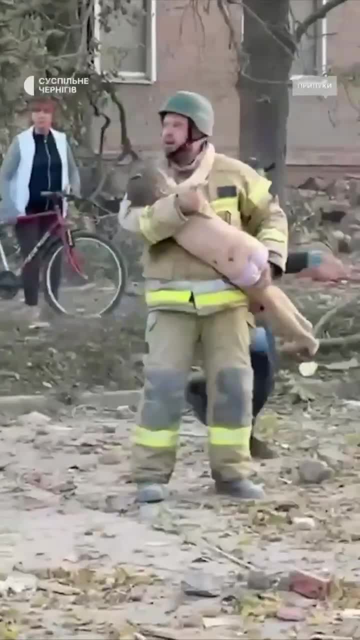 Video thumbnail: Rescuer carries child from building destroyed by Russian strike